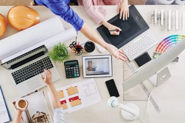 Top view of a desk with a laptop and office supplies